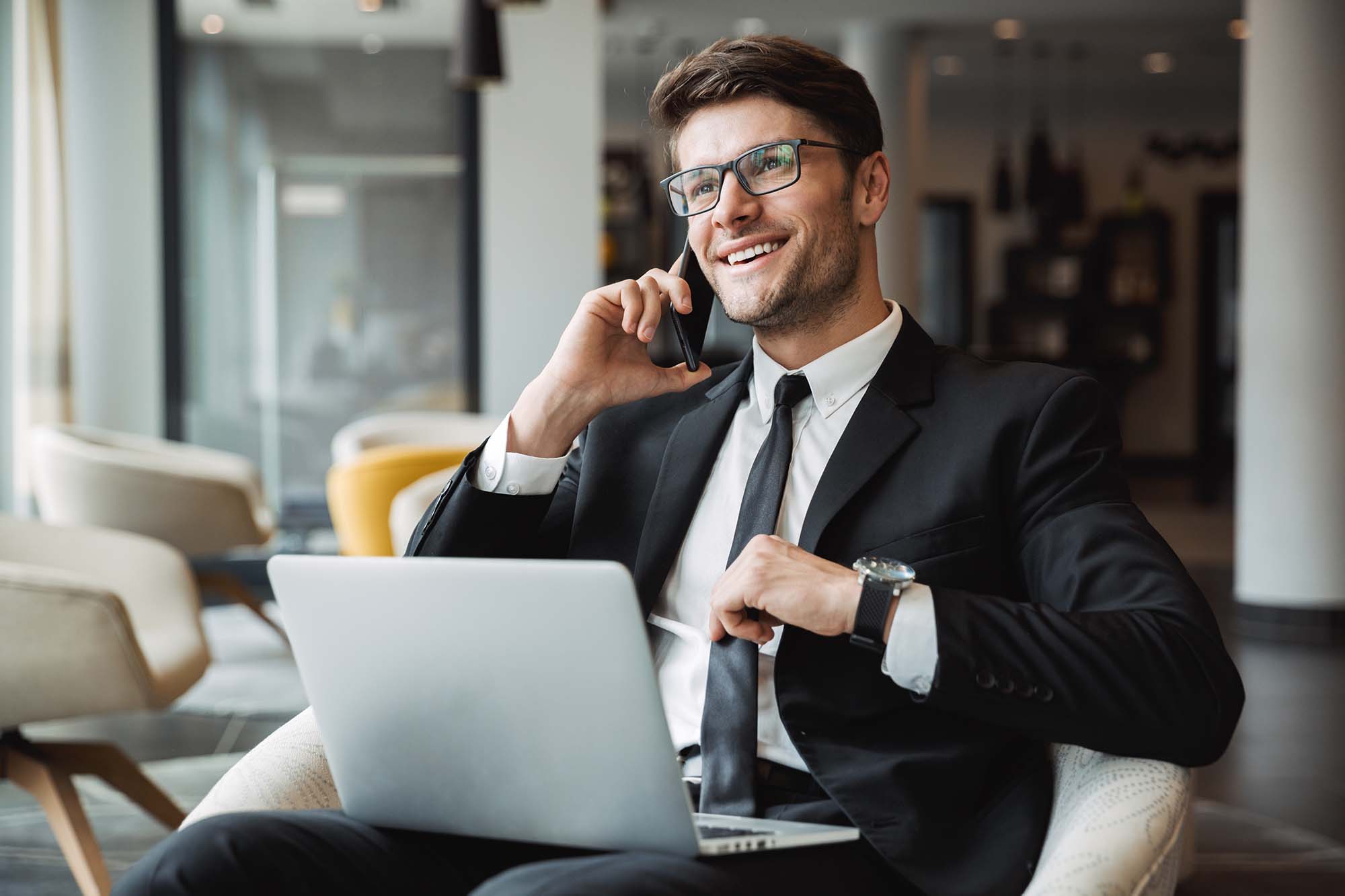 Portrait of happy young businessman using laptop computer and ta eLearning Return on Investment